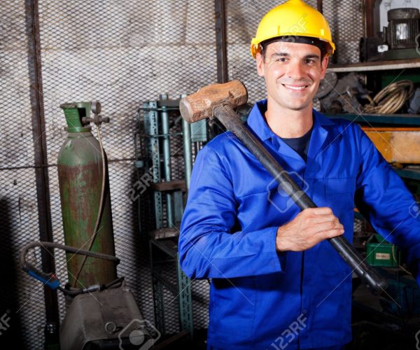 12431977-happy-male-blue-collar-worker-with-a-big-hammer